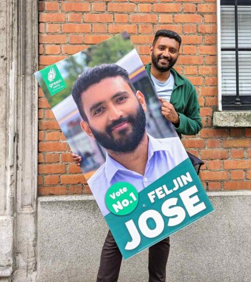 Feljin Jose holding a campaign poster of himself